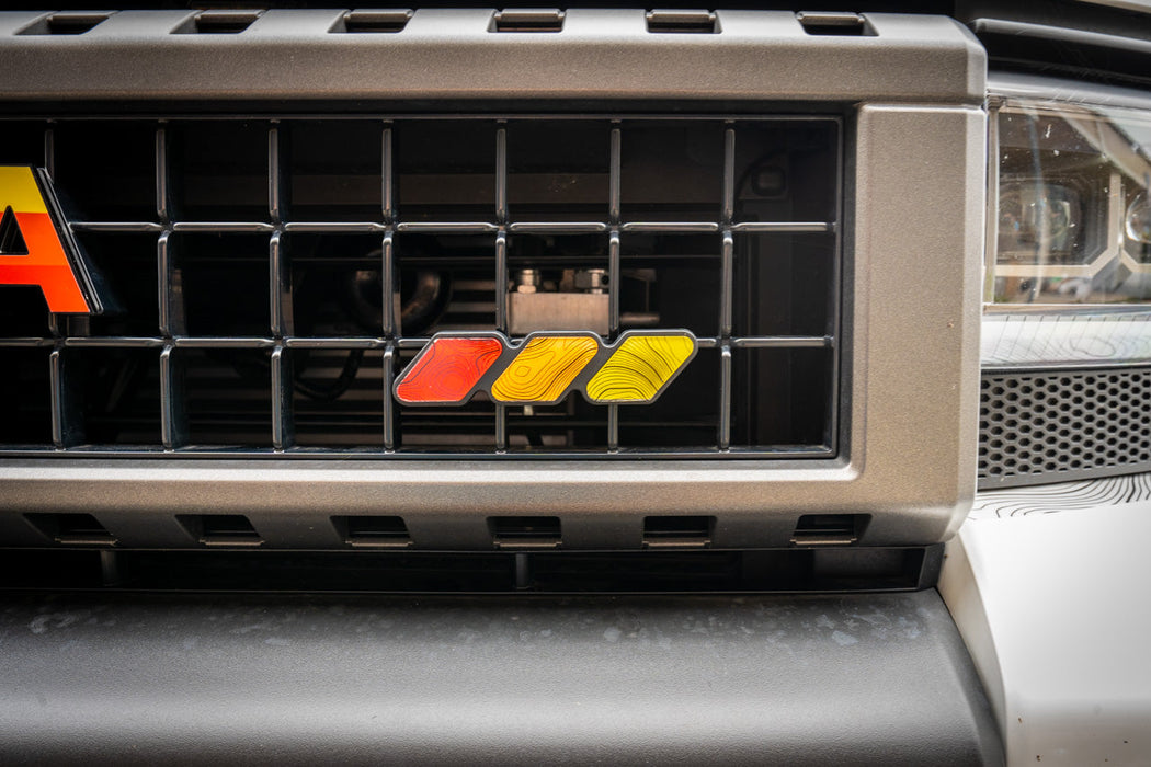 StickerFab Tri Color Topographic Grille Emblem for Tacoma (2016-2023)